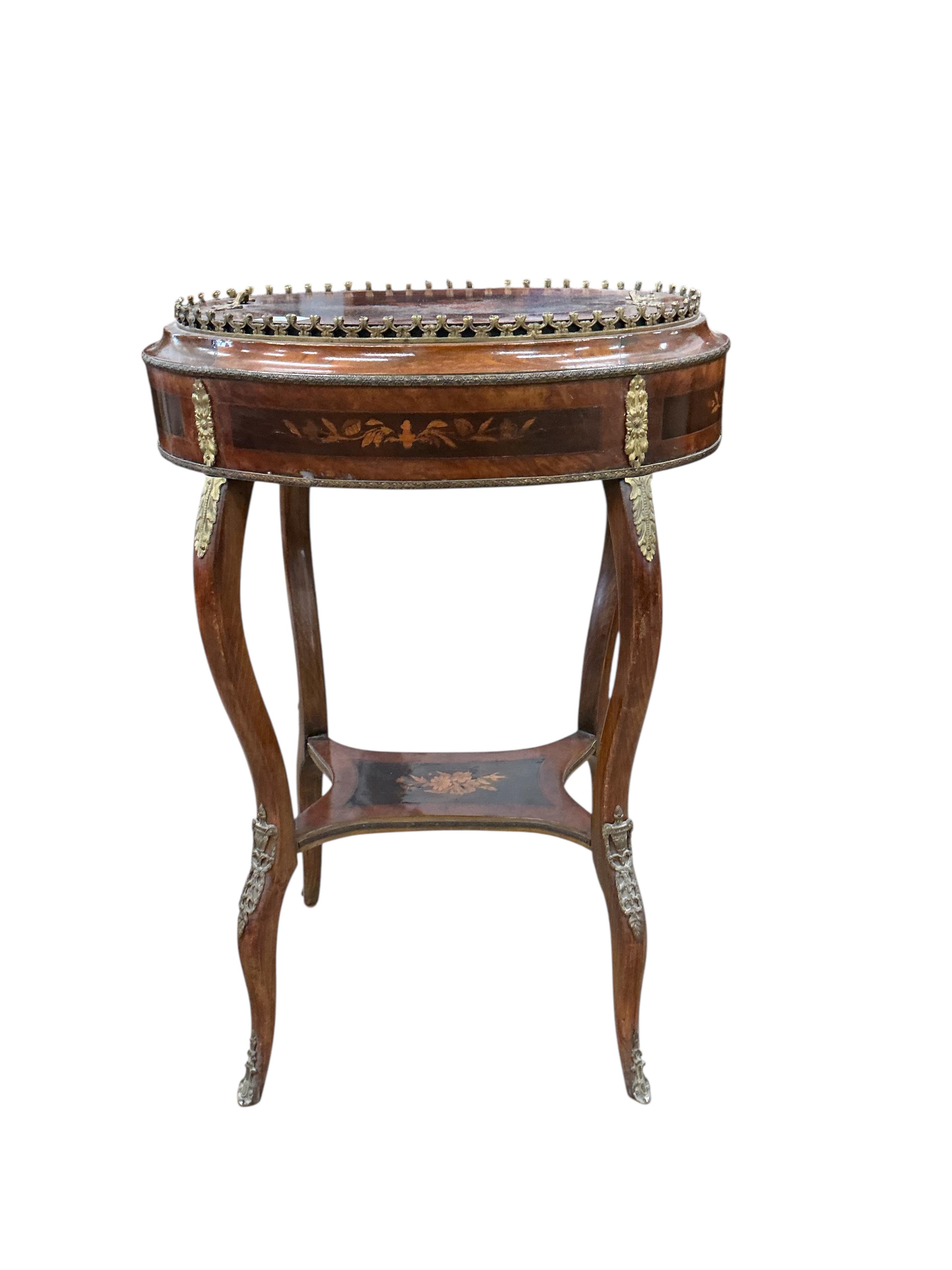 A French Louis XVI style oval gilt metal mounted marquetry inlaid walnut and beech jardiniere table, width 56cm, depth 38cm, height 80cm